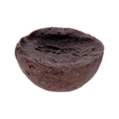 Kaylas Kurlz Organics Whispering Roots Crumble Bar African Black Soap Shampoo half sphere shaped African Black Soap Shampoo bar with a concave face.  It is a placed a against a white background.