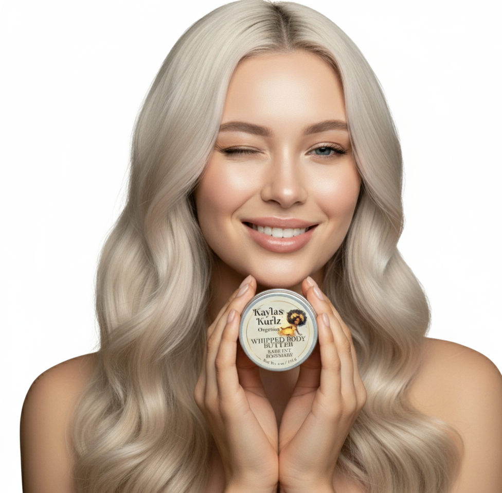 A beautiful woman with loose long curly hair winking her one eye holding a jar of Kayla's Kurlz Organics Radiant Rosemary Whipped Body Butter with a light, creamy texture, gently swirled on top. The packaging features a clean, natural design.